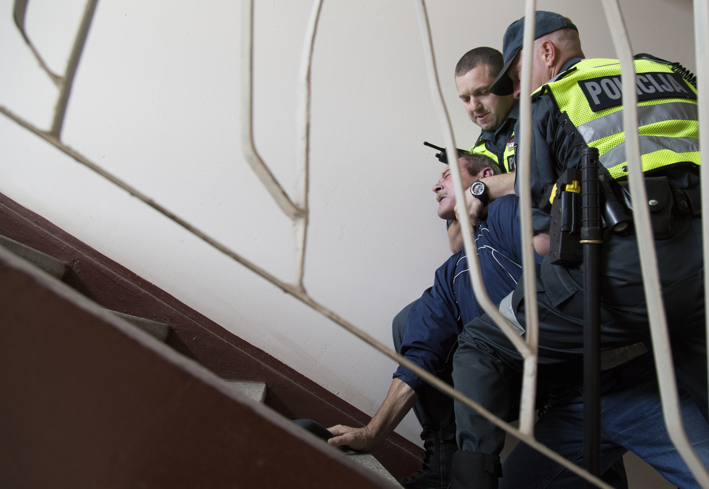 Vilnius police officers Zilvinas Adomaitis and Andrey Gubanov react to a man resisting arrest in an apartment stairwell. The drunk man's wife, who claimed her husband threatened to kill her, made the call for police; however, she did not want to press charges. This was one of two calls that day involving a drunk man threatening his wife. He was legally drunk based on the breathalyzer test. Based on figures from the World Health Organization's recent "Global Report on Alcohol and Health 2014," Lithuania is listed as the third heaviest drinking country in the world. Among other things, alcoholism is seen as a contributing factor to Lithuania's suicide rate.
