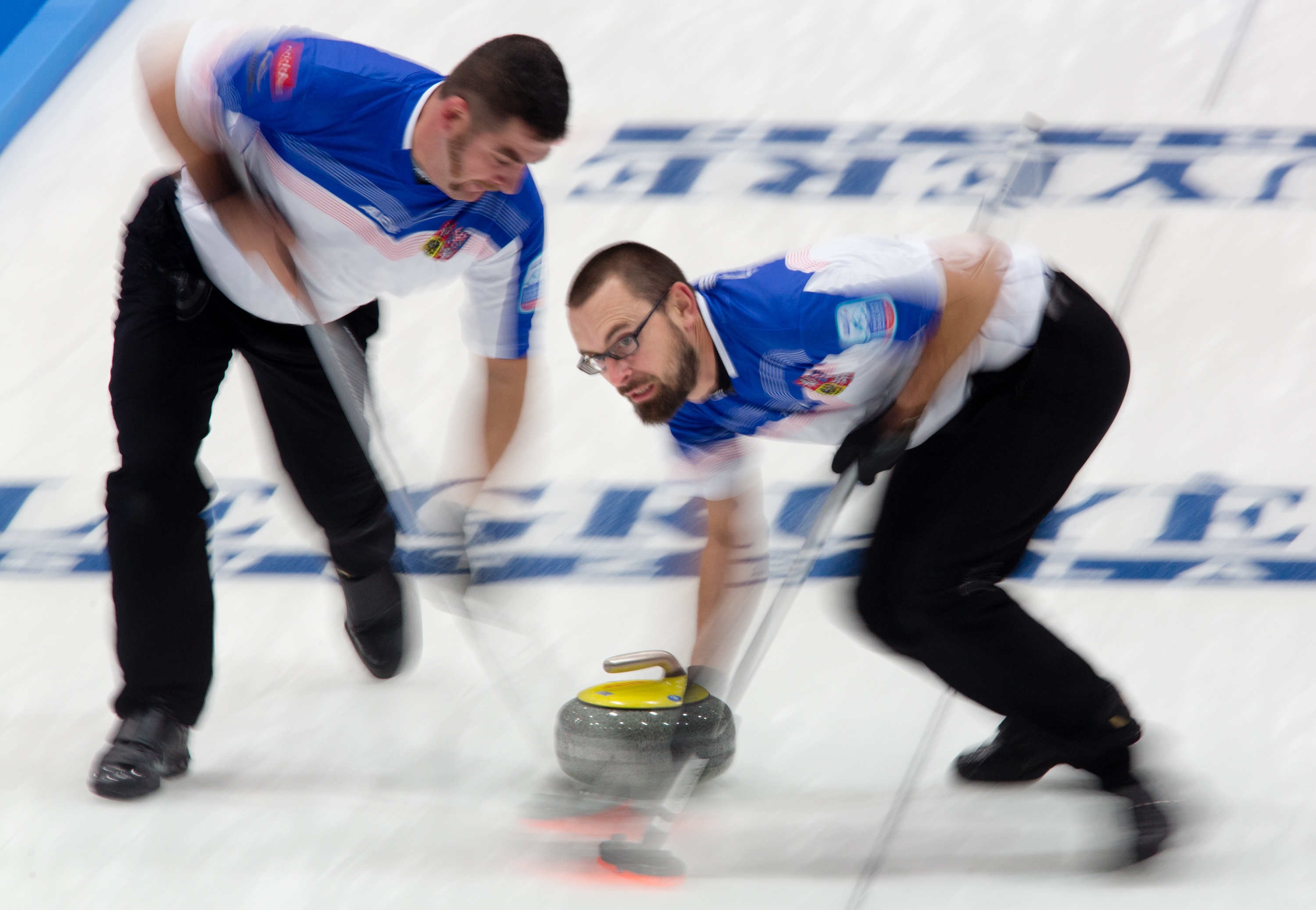 Martin Snitil and Jindrich Kitzberger sweep a stone down the ice at the  Le Gruyre European Curling Championships on 11/22/2014. The Czech Republic ended up in 5th place after losing a tie break game to Norway.