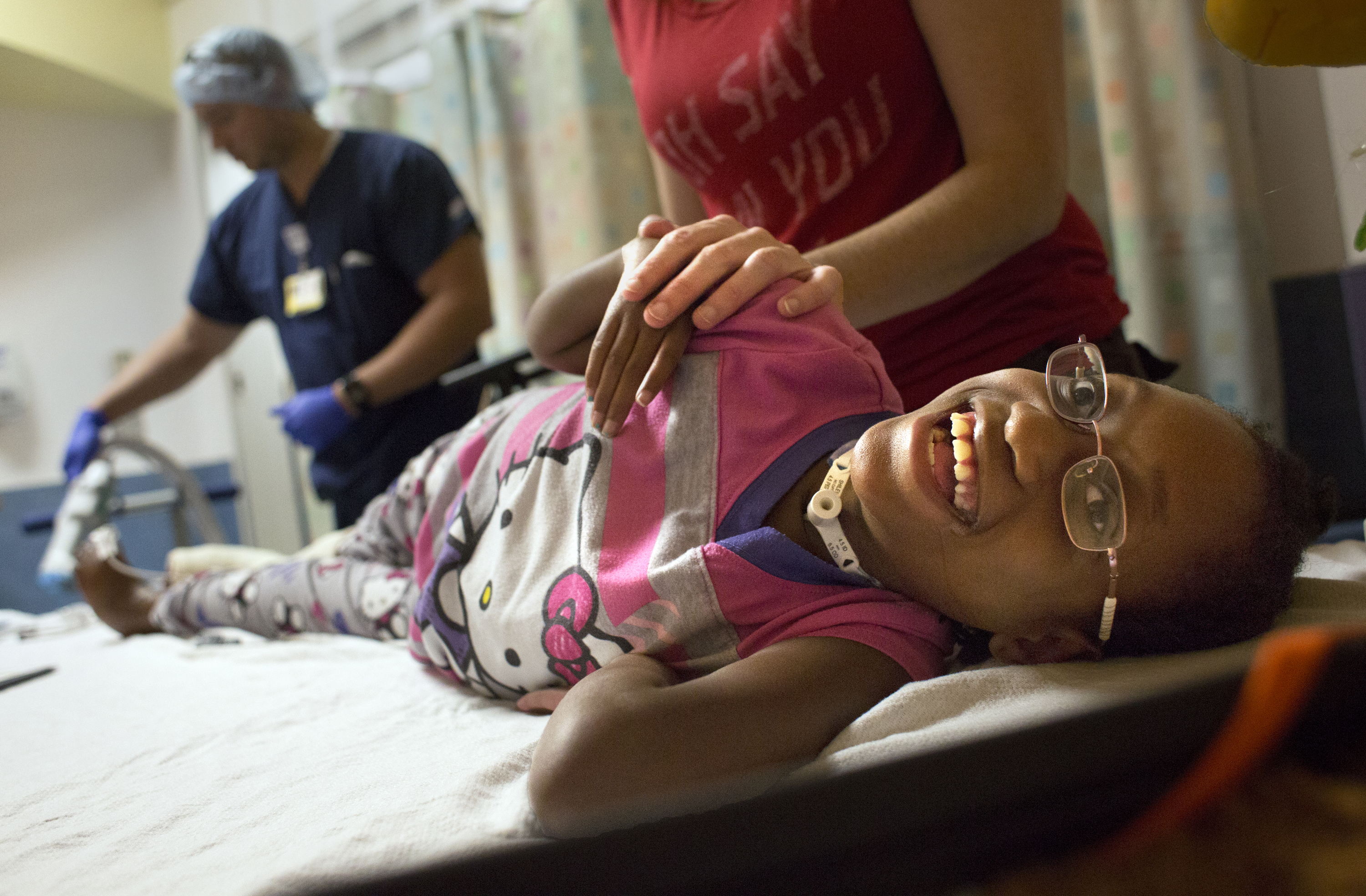 Mary Roko, 9, smiles while feeling the vibrations of a power saw cutting off a cast on her right leg inside the Intensive Care Unit of the Strong Memorial Hospital on Monday, Sept. 14, 2015 in Rochester, N.Y.  "She's real tough", said her mother.  "The strangest things will make her laugh".