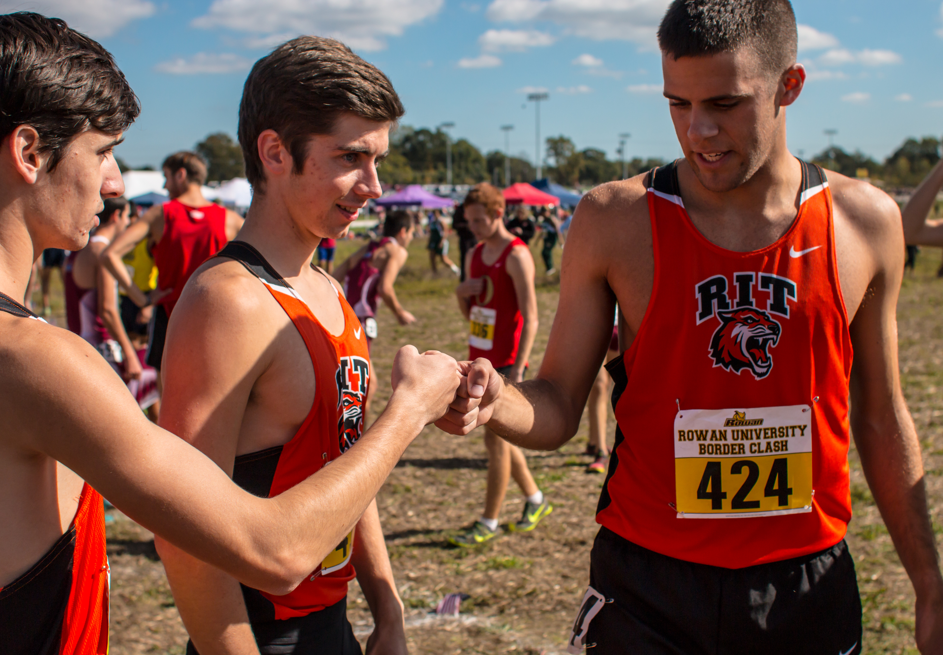 Grant Salk (424) of the Rochester Institute of Technology Tigers talks to teammates moments before starting the men's 8K varsity race on the West campus of Rowan University in Glassboro, N.J. on Oct. 15, 2016.