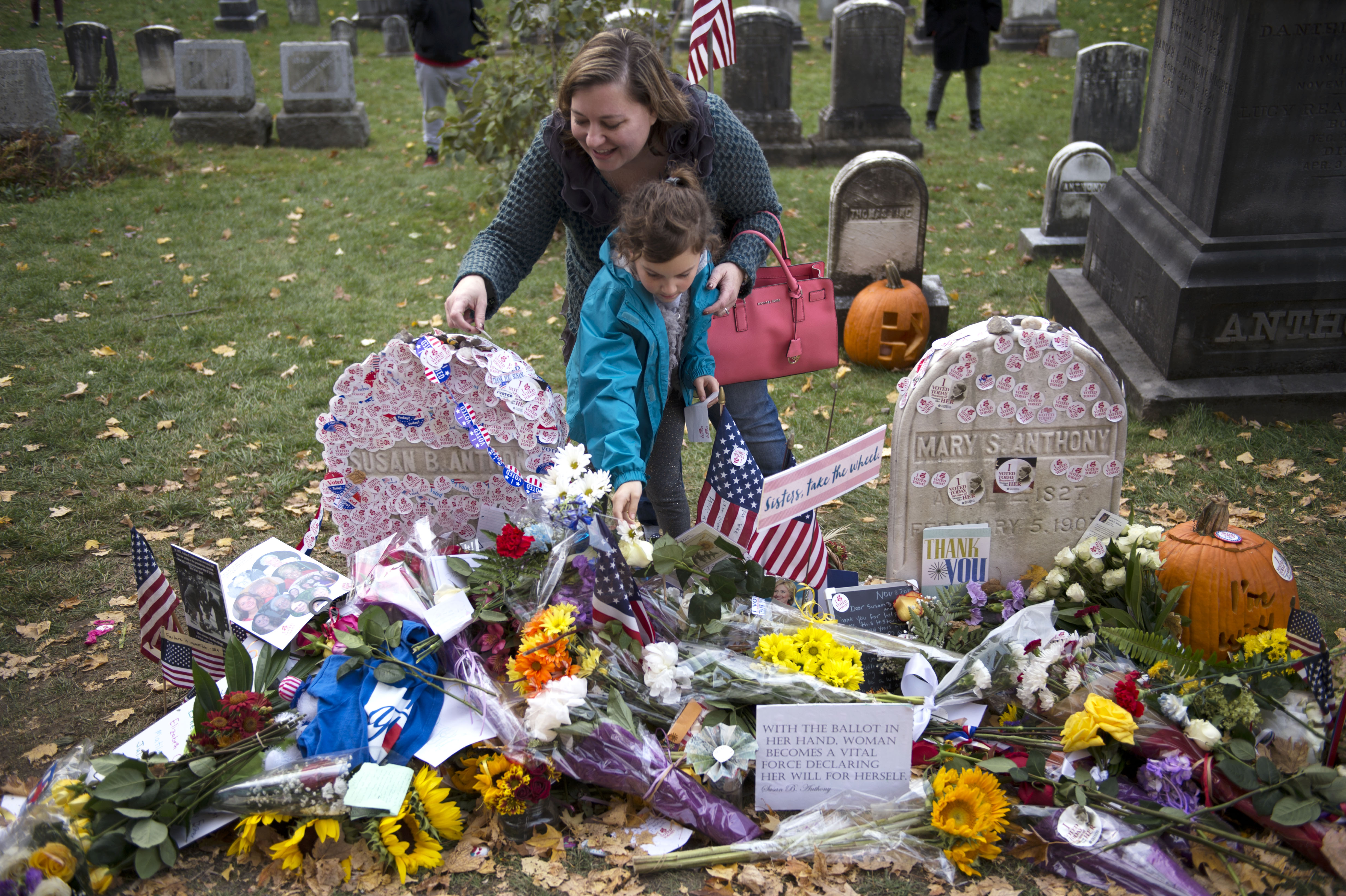 Voters place their stickers on Susan B. Anthony's grave in Mount Hope Cemetery after being able to vote for a woman on a major party ballot for the first time in Rochester, N.Y. on Nov. 8, 2016.