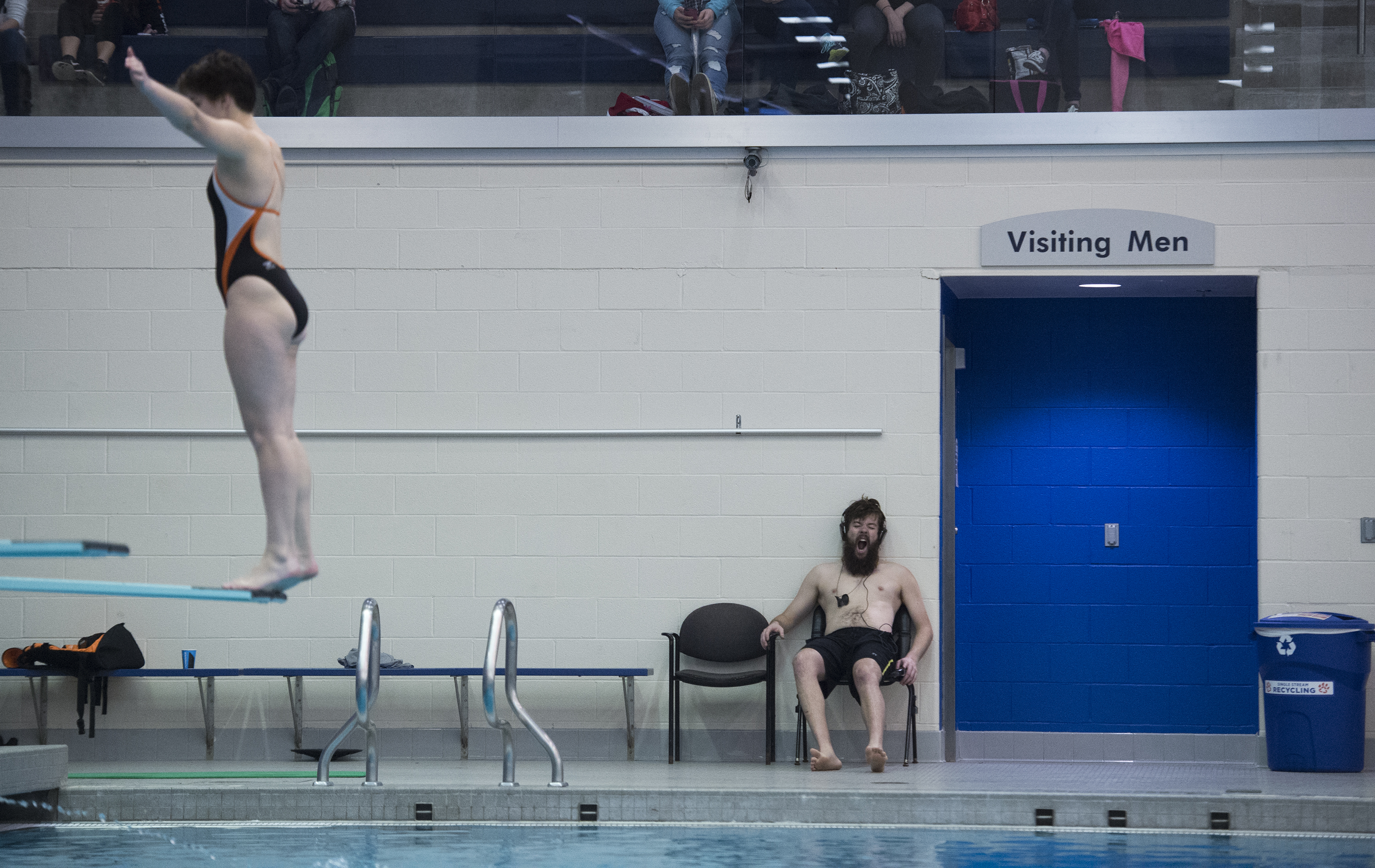 Patrick McFadden, a freshman from Alfred State University, yawns while Madeline Wolters, a Sophomore from Rochester Institute of Technology (RIT), performs a one meter dive at Judson Pool on the RIT Campus, on Nov. 19, 2016, in Henrietta, N.Y. RIT won the meet, with a women's score of 148-96, and a men's score of 186.5-103.